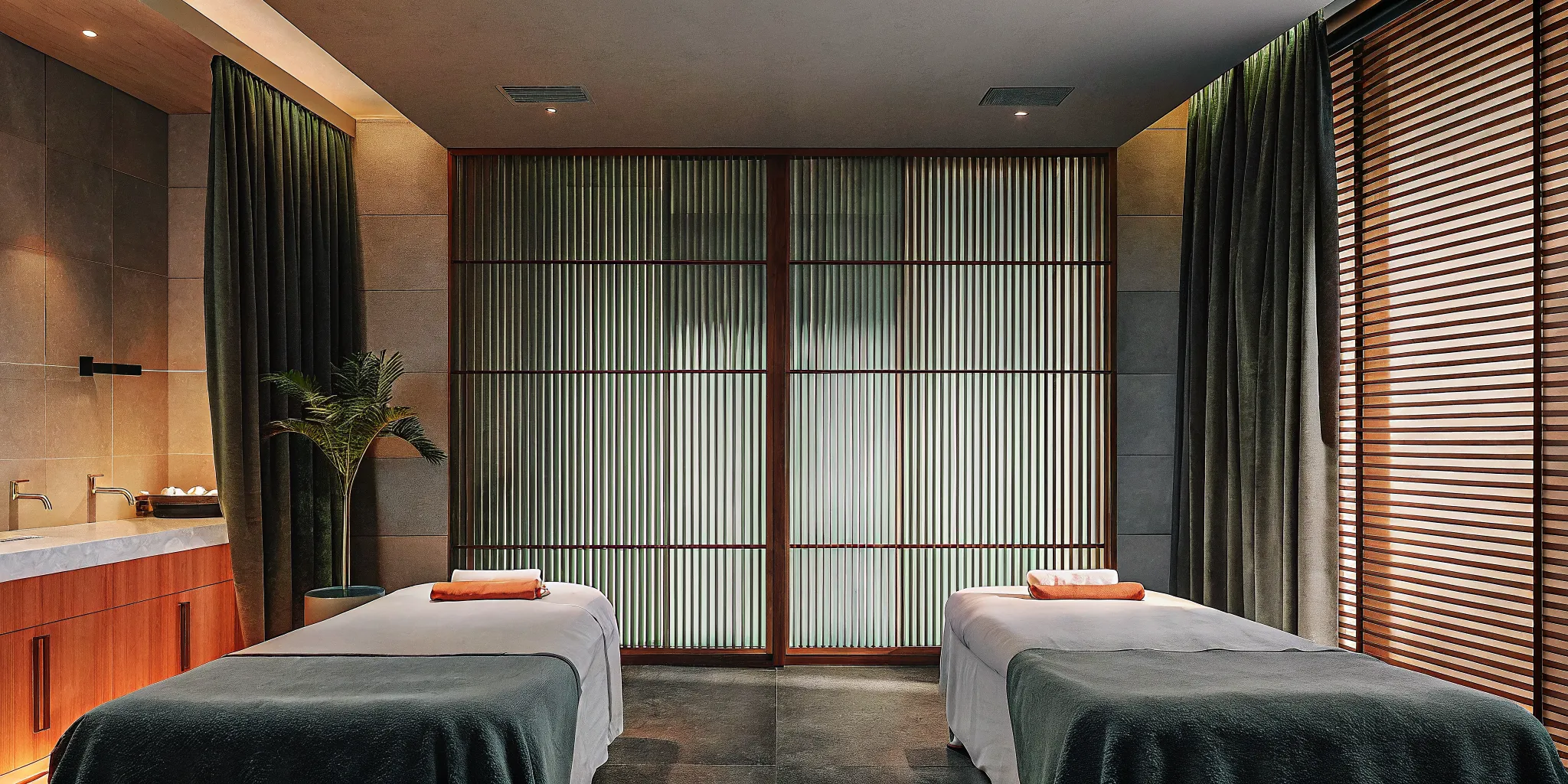 Two massage tables in a spa room set up for an ashiatsu vs deep tissue massage.