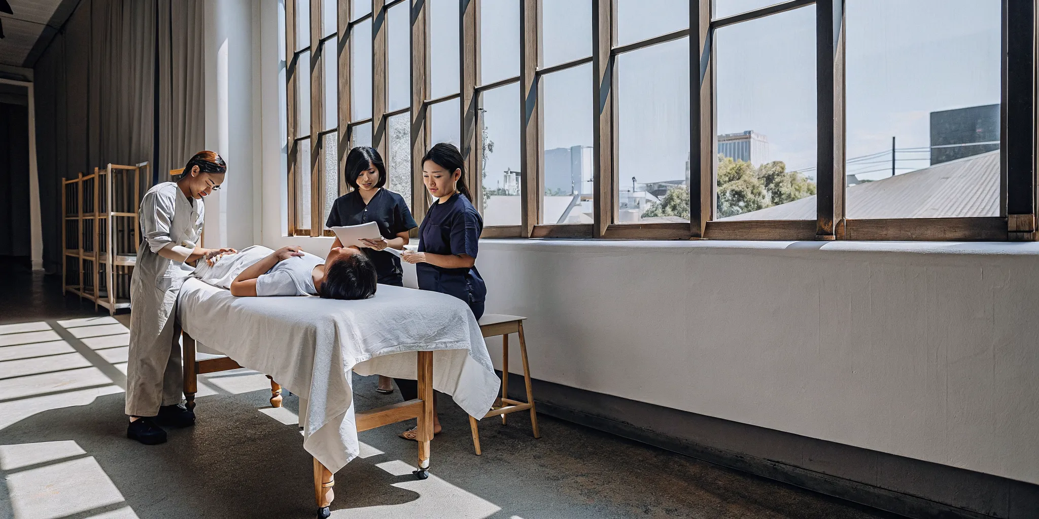 Massage therapists at a hands-on, in-person CEU class.