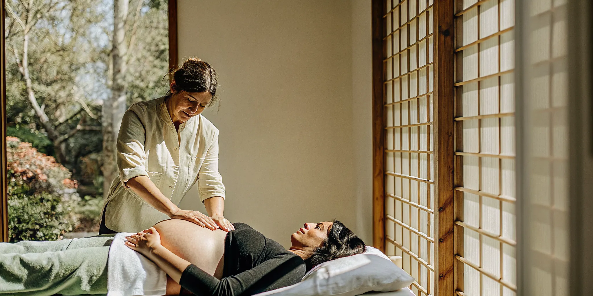 Pregnant client receiving a comfortable side-lying prenatal massage