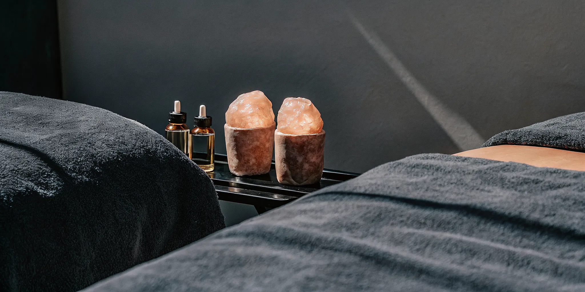 CBD massage enhancement oil and Himalayan salt stones prepared for a massage